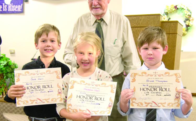 Pastor Jim Lewis recognized Pastor’s Honor Roll students Gus Hall, Haddon Hall and Bruce Thompson at a recent awards ceremony at Life Christian School.