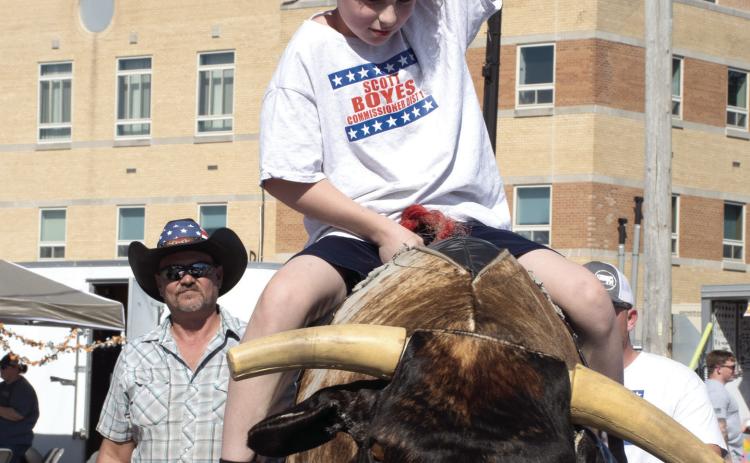 Mechanical bull riding was popular among those attending the Columbus Day Festival. Mason Boyes of Galena took his turn riding the mechanical bull Saturday, October 10.