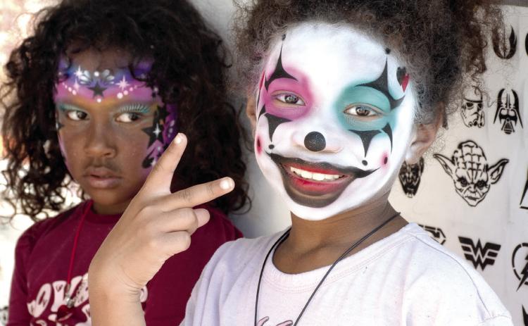 Liliana McCray of Columbus and Nylah Fermin of Joplin, Mo. were two of many youngsters who got their face painted during the Annual Columbus Day Festival art and craft show October 10.