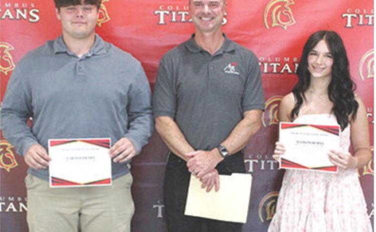 Carter Henry and Allison Burns each received a $1,000 American Bank Scholarship from bank president, Jim Gaither, during the 2025 Columbus Unified High School Senior Assembly, May 16 at the CUHS Gymnasium.