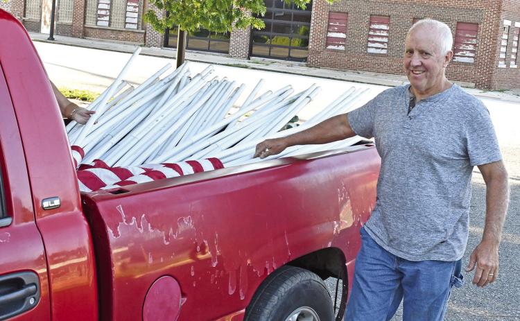 Baxter Springs Mayor Kelly Abbott was taking down the flags members of the Kiwanis Club had put up for Memorial Day. The club places flags around town for all patriotic celebrations.