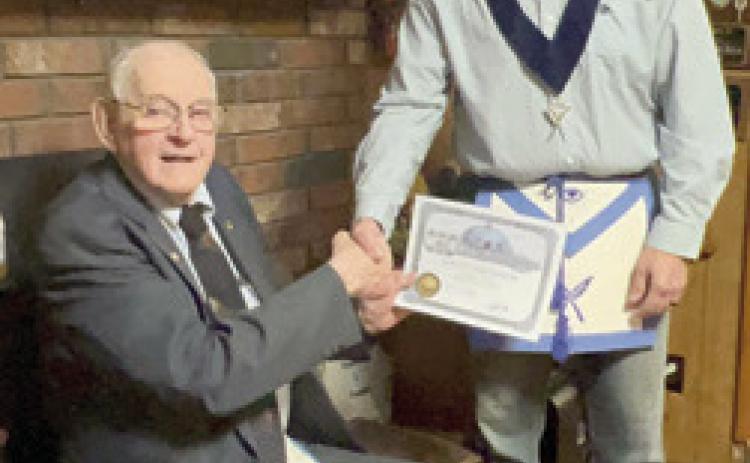 Harold Shideler received his 65 year membership pin and certificate in the AF&amp;AM lodge Tuesday, March 21. Tom Circle, Secretary of Parsons AF&amp;AM #117, presented these to Shideler at his home. There were 15 family members present for the occasion. Shideler became a member of the McCune AF&amp;AM # 232 in 1958. He transferred to Parsons when McCune closed. He filled different chairs and was Past Master twice. He remains a loyal supporter at age 94. Courtesy photo.