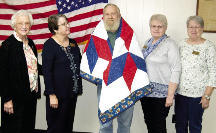 Quilts of Valor were presented to Gary Groves, a Viet Nam era veteran, by the members of the Quilts of Valor Southeast Kansas organization located in Pittsburg. The ladies meet once each week and make the quilts from patterns approved by the national Quilts of Valor organization. The quilt was presented by Nora Arnold, Kathi Lunday, Janie Fletcher and Alice Walters.
