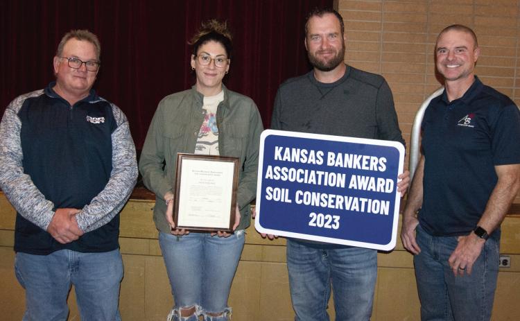 The Banker’s Award was presented to Nick and Emily Smith by Carl Mussa, (left) Soil and Water Conservation Chairman an Jim Gaither, County Key Banker, (right).