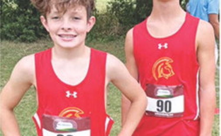 Titan eighth graders Tanner Scott (seventh place) and Eli Engelman (fifth) competed in the Oswego Cross Country Meet, September 18. Courtesy photo.