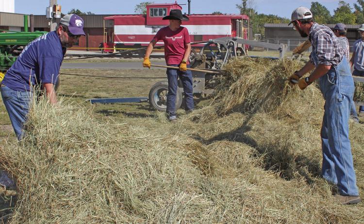 Getting the hay ready to load into the baler would take considerable time even with several workers assisting.