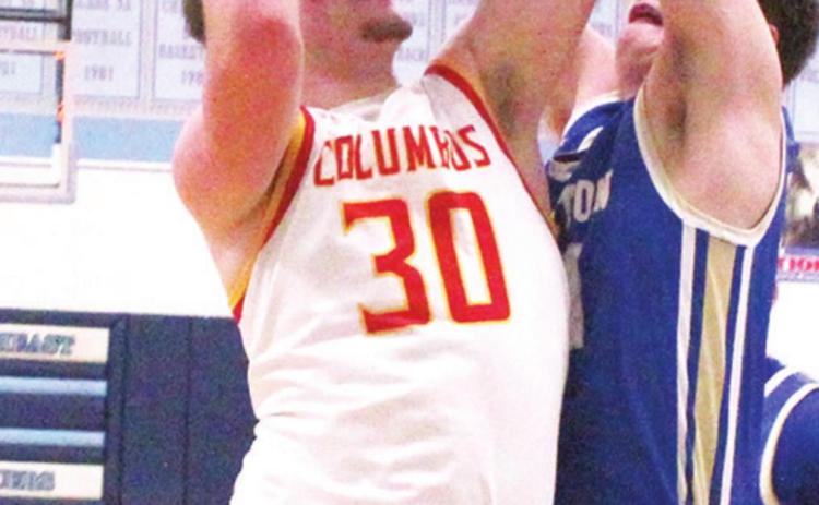 Brett Hamilton, Titan Junior, goes up for two of his team-high, 19 points, against Riverton defender, sophomore, Loch North. Brett hit a three pointer with 30 seconds to play in regulation to send the game into overtime and the eventual Columbus win, 62-59.