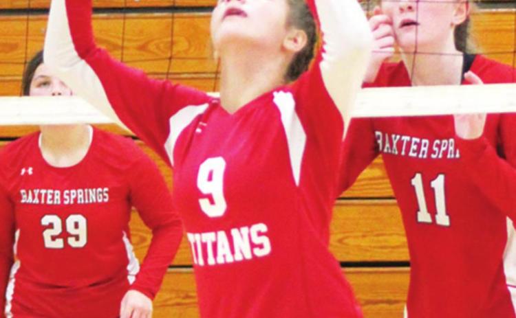 Lady Titan Ellie Helms sets the ball for her team mate in the September, eighth grade tournament at CUHS. Emerson Skye and Devyn Hopkins, Baxter Springs await the return.