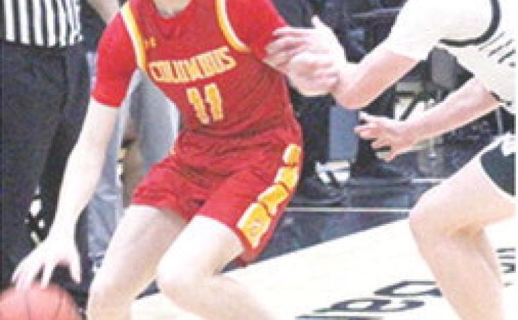 Titan Freshman, Jonas Stover, works toward the basket against Raider Junior, Jake Wegner, in the CNC loss at Frontenac, Monday. Stover led the Titans with eight points.