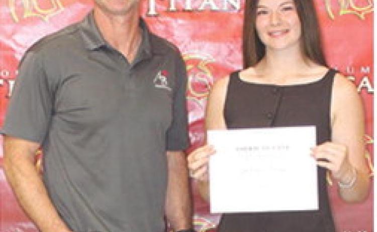 Senior Katelyn Draeger received the $1,000 American Bank Scholarship from Bank Executive, Jim Gaither, during the Columbus Unified High School Senior Assembly, May 15, at the gymnasium.