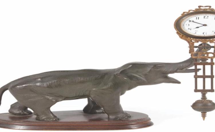 This elephant is swinging the clock, but there doesn’t seem to be anything making it move. That is why it is known as a swinger or mystery clock. It is 11 inches tall.