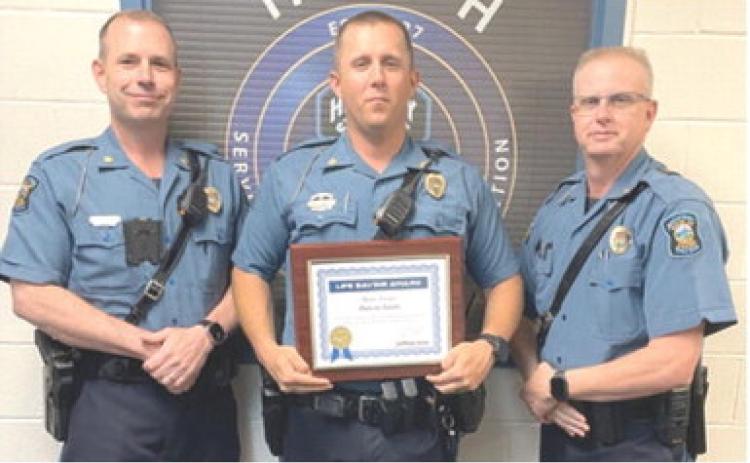 Ian Ingram presented the Life Saving certificate to Master Highway Patrol Trooper Dakota Smith as Captain Mark Drennan looks on. Courtesy photo.