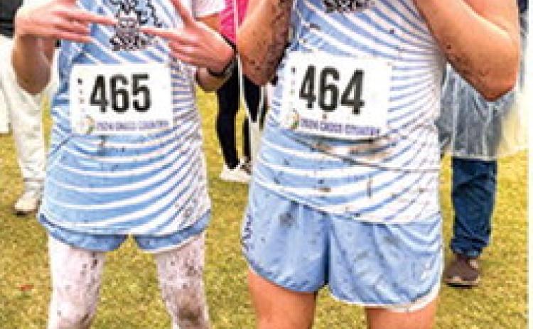 Tucker Sutton, freshman, and Zane Gabern, were a little worse for the wear after finishing the Kansas Class 2A State Cross Country 5K Race, Saturday, at Rim Rock Ranch in Lawrence. Courtesy photo.