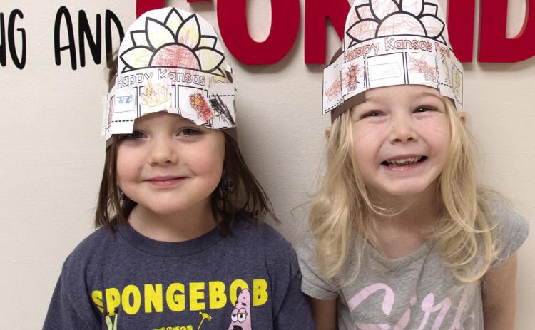 Youngsters at Columbus schools recently celebrated Kansas Day. Olivia Meredith and Hattie Napier created sunflower hats to recognize the state flower.