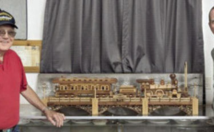 The Heart of the Heartlands Museum President Larry Spahn received the donation of a 1/24 scale wooden steam locomotive and coach car from Brian Troglia. Troglia said the train took him approximately 500 hours over four months to build. He used Cedar, Walnut, and Oak, all harvested and milled locally, to build it. Courtesy photo.