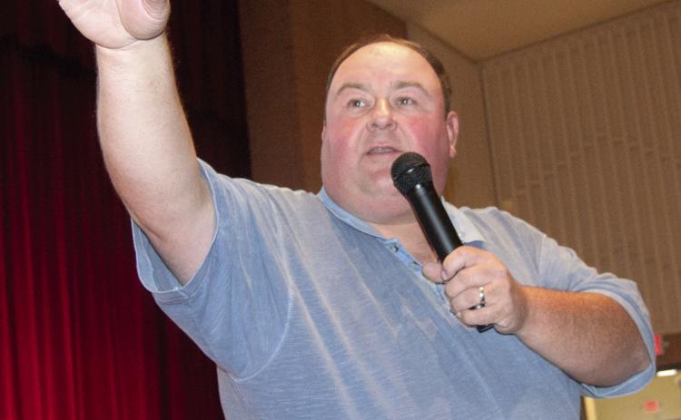 Auctioneer David Holmes watched the crowd for bidders during the County Delinquent Tax Auction held in the Columbus High School auditorium Monday afternoon. Over 100 bidders returned 87 properties to the tax rolls.