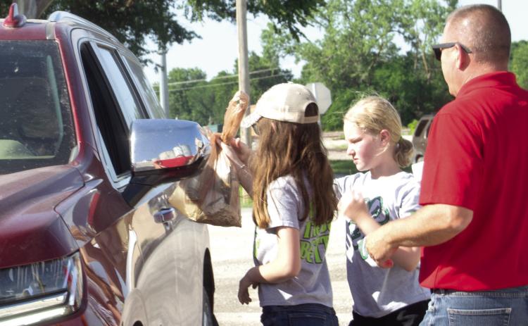4-H Club members Cora Welch and Riley Holmes take an order during the Columbus Chamber of Commerce Feed the Farmers day on last Thursday. The annual program is the Chamber member’s salute to the agriculture community and what it means to the area.