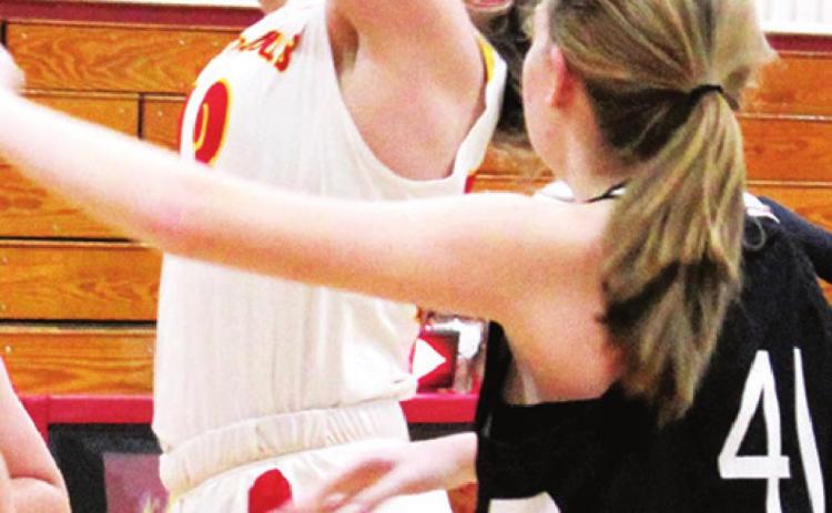 Lady Titan Freshman, Macey Allison, gets a rebound in the junior varsity game against Frontenac, Friday at the CUHS Gym. Lady Raider Freshman, Kayle Hensley awaits the outcome.