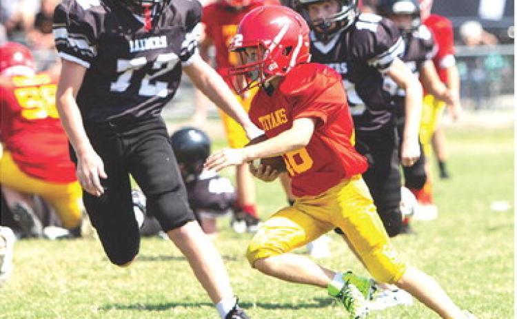 The Columbus Fifth and Sixth Grade Titan Team hosted Frontenac, September 16, at Titan Stadium. Tanner Scott ran up against some big guys on defense during a good run. The visitors clipped the locals, 26-20 in double overtime, handing Columbus their first loss of the season. Photo courtesy Kristin Sharp.