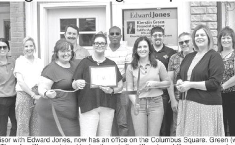 K cutting for her new business Thursday. She was joined by family and other Chamber of Commerce members as she was welcomed to the communi Green, financial advisor with Edward Jones, now has an office on the Columbus Green (with scissors) had a ribbon