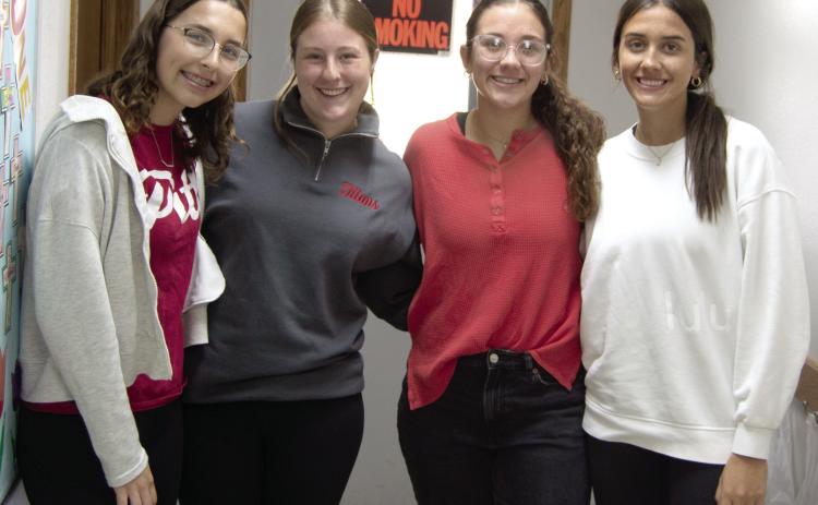 Torey Tedlock, Taryn Billings, Katy Mooney and Bryleigh Johnson were kept busy during the baked potato fundraiser put on by the Columbus PEO. Proceeds will be used to fund scholarships for young women to attend college.