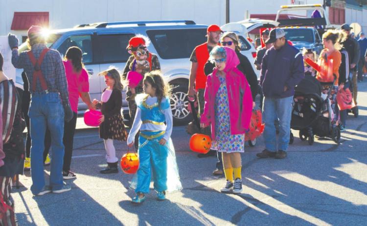 Part of the crowd for the Halloween Trunk or Treat event along Pine St. in Columbus, line up for candy at each of the vehicles parked along the street. Colorful costumes intermingled with the festive and creative displays for a day of family fun thanks to the Columbus Chamber of Commerce’s organization and resources. Photo by Jacob Spencer