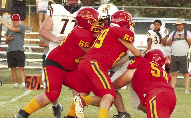Titan Juniors, Huck Hallam and JW Tate, and sophomore, Maddox Ochsner take down the Coffeyville runner in the backfield, short of the scrimmage line in the junior varsity match up, Monday, at Titan Stadium. The Golden Tornados took the win, 28-0.