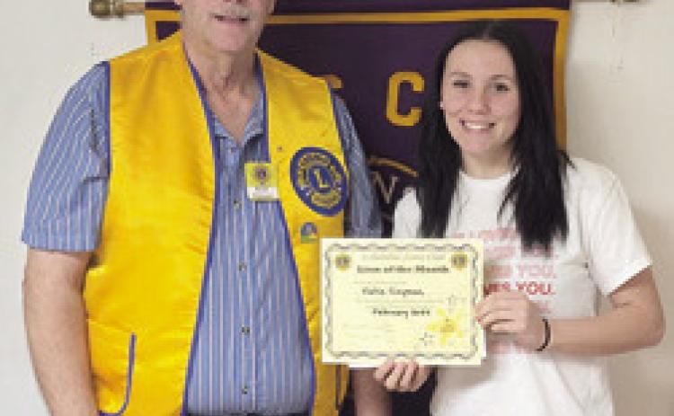 Brad Gleason presented February Lion of the Month Katie Simpson with her certificate at a recent meeting. Courtesy photo.