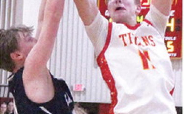 Titan Sophomore, Jonas Stover, goes up for the goahead basket with 1:32 on the game clock. Jonas made the and-one free throw for a two-point, 47-45, lead in the 50-47 win over Galena, Thursday at the CUHS Gymnasium.