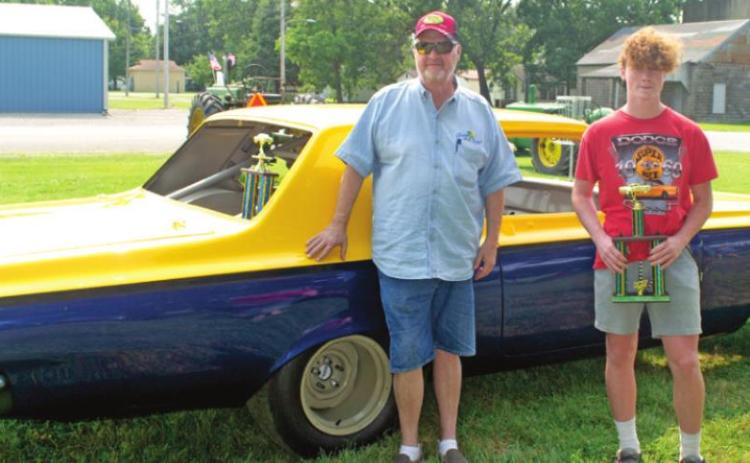 Award winners at the Cherokee Homecoming car show on Saturday included Jack Johnson and Aden Smith. Smith was recognized as the future of the car show and Johnson was recognized for his dedication to the show over the years. Both winners are in front of one of three cars shown by Johnson.