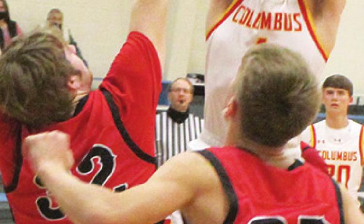 Senior, Traceton Redlon, scored two points for the Columbus Titans in their 52-41, win over the outstretched arm of Baxter Springs, sophomore, Logan Gess, Tuesday in Cherokee. Lion Freshman, Payton Gaines moves in for a possible rebound in the first round of play in the Southeast Lancer Classic Basketball Tournament.