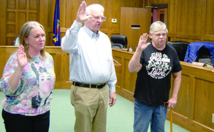 Newly elected Columbus City Council member Laura Epler (left) was sworn into to her Ward 1 position on Tuesday evening by City Clerk Ruth Hutley. Former City Council members Tom Pryor and Kathy Doherty were also sworn in by Hutley as they returned to office.