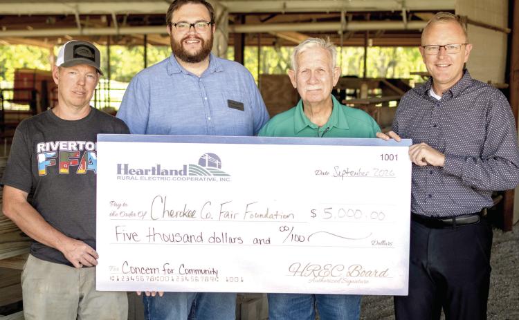 Cherokee County Fair Board members Aaron Asher, Terry North and Brad Wells accepted a check for $5,000 from Heartland REC representative Doug Graham, to improve accessibility at the fairgrounds in Columbus. Courtesy photo.