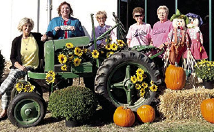 Businesses in Baxter Springs participated in a fall decorating contest sponsored by PEO Chapter BT. First place was awarded to Baxter Springs City Hall. Patti Shaw and Dawn Reeser accepted their prize from PEO judges Deann Binns, Kathryn Aupperle and Delores Crane.