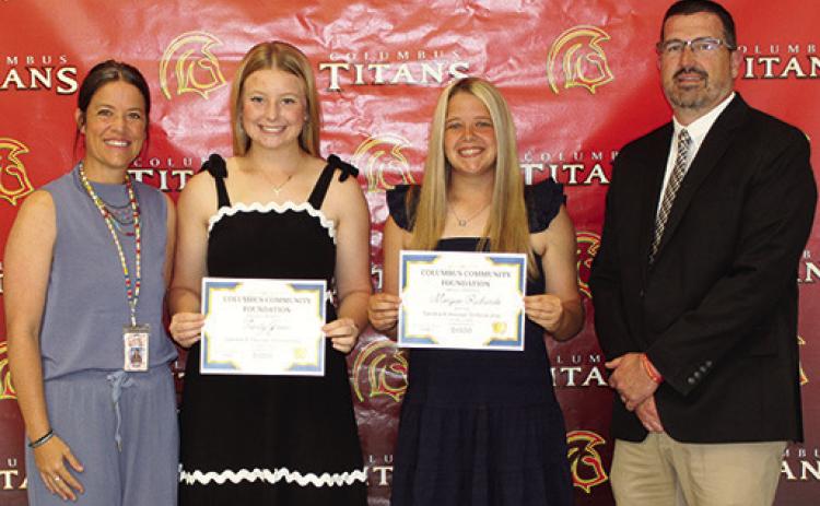 Trinity Green and Morgan Richards received the Sandra B. Houser Memorial Scholarship in the amount of $1,000 each from CACF Board Member, Kelly Walters and USD 493 Superintendent Dan Grundy during the Senior Assembly, May 15, at the Columbus Unified High School Gymnasium.