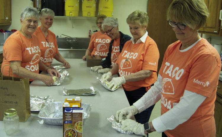 Mary Brumback, Debra Messer, Clara White, Beverly Rahmeier, Jane Ann Turner and Marilyn Epler wrapped tortillas for the Cinco de Mayo fundraiser held by Columbus Mercy Auxiliary. Chicken soft tacos with all the toppings were on the menu.