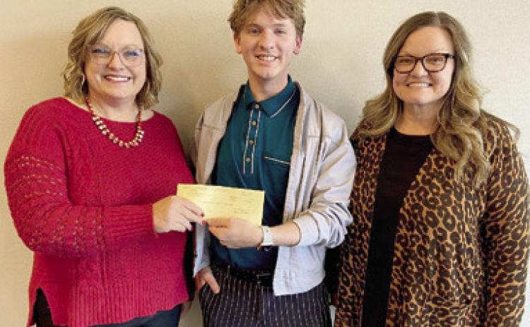 Southeast High School graduate Peyton Simpson (center) had the winning logo design for Labette Community College’s 100th anniversary. Simpson is also a graduate of LCC’s Graphic Design Technology program. Lindi Forbes, Foundation and Alumni Director (left) and Melissa Kipp, Professor of Graphic Design (right) presented Simpson with his award. Courtesy photo.