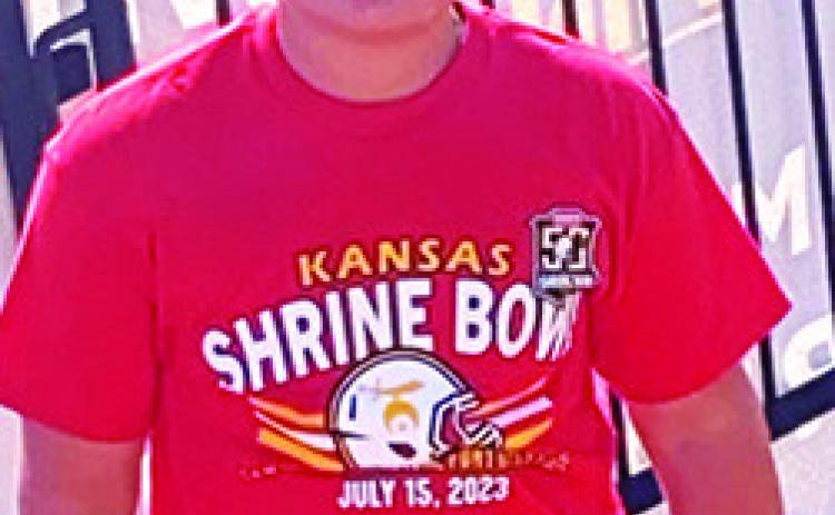 Columbus Titan Ethan Midgett has been ball boy and bat boy for his brother Landin’s ball teams for many years. Saturday was no different when the incoming CUHS Freshman was on the sideline serving as ball boy for the 50th Annual Kansas Shrine Bowl Game in Hays. Courtesy Photo.