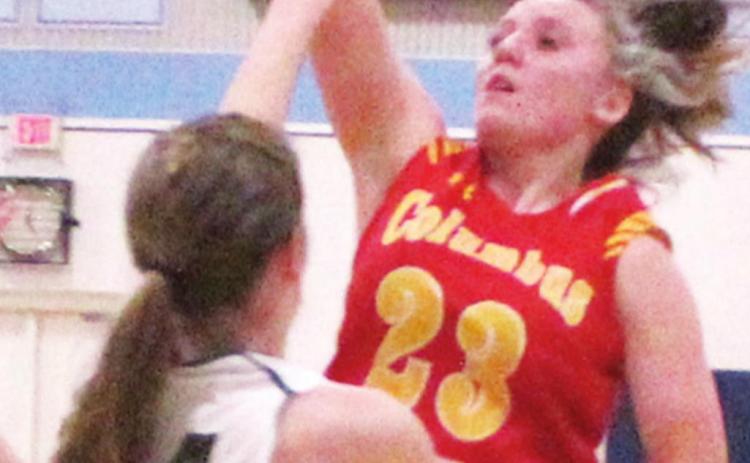 Lady Titan Sophomore, Katie Simpson, shoots over Lady Cougar sophomore, Maddy Conlin, during the first round Columbus win, 43-40, in the Lancer Classic, Monday, at Southeast High School.