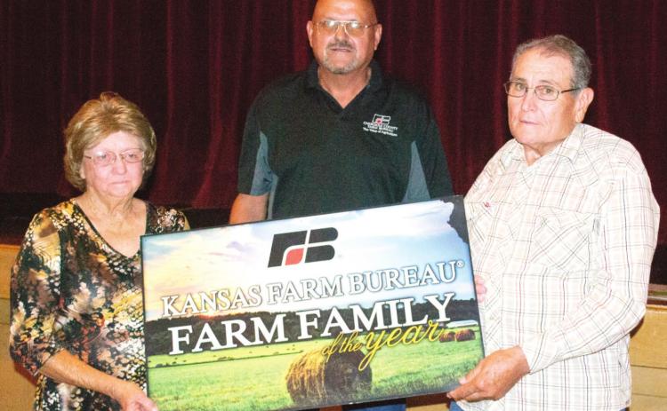 Ronnie and Sharon Johnson received the sign signifying their selection as Farm Family of the year. The presentation was made by Cherokee County Farm Bureau President Jack Getman.