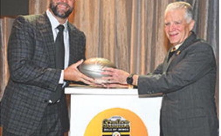 Ben Roethlisberger receives his commemorative football from Steelers President Art Rooney II upon his selection into the Steelers Hall of Honor Class of 2025. Roethlisberber joins linebacker, Joey Porter Sr. and center, Maurkice Pouncey. The ceremony took place over the weekend at Acrisure Stadium in Pittsburg. Courtesy photo Steelers.com.