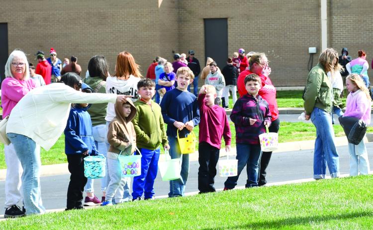 Each year the Baxter Springs Kiwanis Club Easter egg hunt draws a large crowd. Many youngsters waited for the race to the eggs to begin. The hunt was held Saturday at Baxter Springs High School.