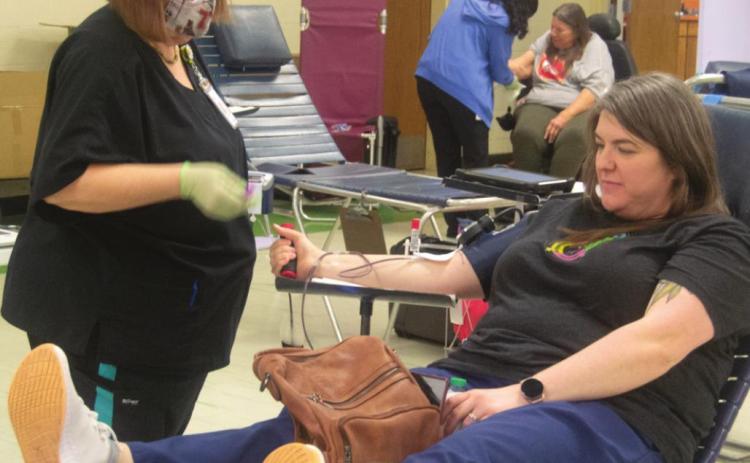 Kara Parker gets her blood taken by Donna Perkins during the February 21 blood drive in the Columbus Community Building. The Community Blood Bank of the Ozarks set a goal of 30 donations and received over 40 by the end of the day. Photo by Jacob Spencer.