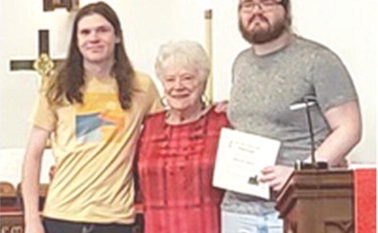 Atticus Johnson, Nancy Evans and Eliott Johnson were in attendance at the First United Methodist Church June 8 Evans presented each of the Johnsons with $1,000 scholarships. Courtesy photo.
