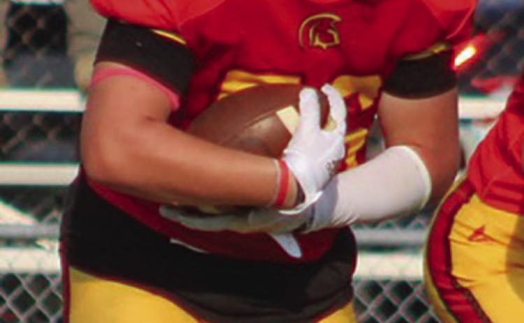 Titan Eighth Grader, Kash Smith, punched through the line for a one-yard touchdown, Thursday, at Girard. Columbus took a 32-20 win over the Trojans in the CCCJL contest.