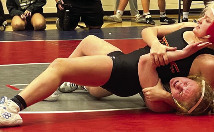 Emily Britt, Lady TItan Junior, pins her opponent during action at the Bentonville West High School Tournament, Friday, in Centerton, Ark. Emily placed third in the 135-pound weight class Photo courtesy of Amanda Stone.