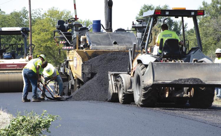 With asphalting season coming to a close, crews with APEC, a contractor hired by the City of Columbus to complete the 2026 street overlays, worked in the 400 block of East Sycamore, just east of the railroad crossing, laying a fresh pad of asphalt.