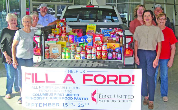 The Ford pick-up truck loaded with 840 pounds of groceries, collected by Mike Carpino Ford was delivered to the Columbus United Methodist Church food pantry after two weeks of collection. Those with the truck include on the left side Nancy Evans, Sharon Draeger, Sue McKenzie and Robbie Carpino. On the right-side, Jamie Huston, Jay Wary, Hannah Carpino and Anita Davolt.