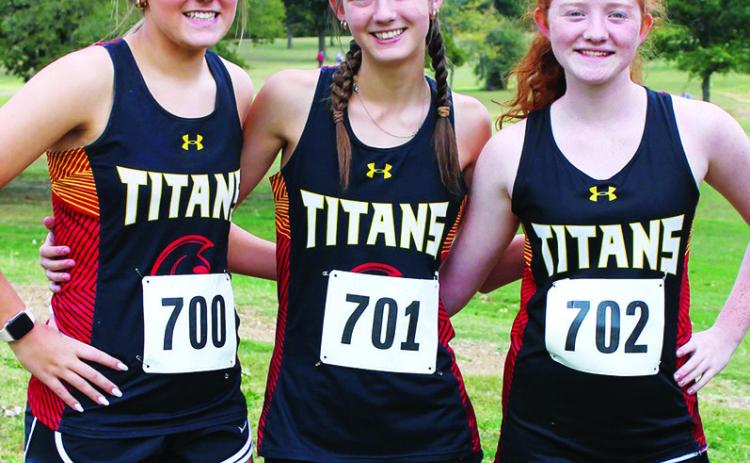 Lady Titans Kenadie Carter, Darcy Garett, and Kennedy Riechardt and the Titan Cross Country Team hosted the CNC League Cross Country Meet, at the Brush Creek Golf Course, October 12.