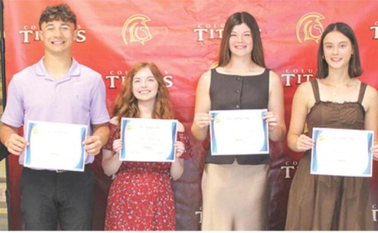 Titan Seniors Jayden Rodriguez, Ava Hulvey, Katelyn Draeger, Piper Hayes, and Lemmie Stone each received a $300 CJSHS Business Scholarship from Instructor Laura Boeckman during the Columbus Unified High School Senior Awards Assembly, May 15, in the high school gymnasium.
